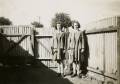 Bette and Barb in their St Aloysius College uniforms in the backyard